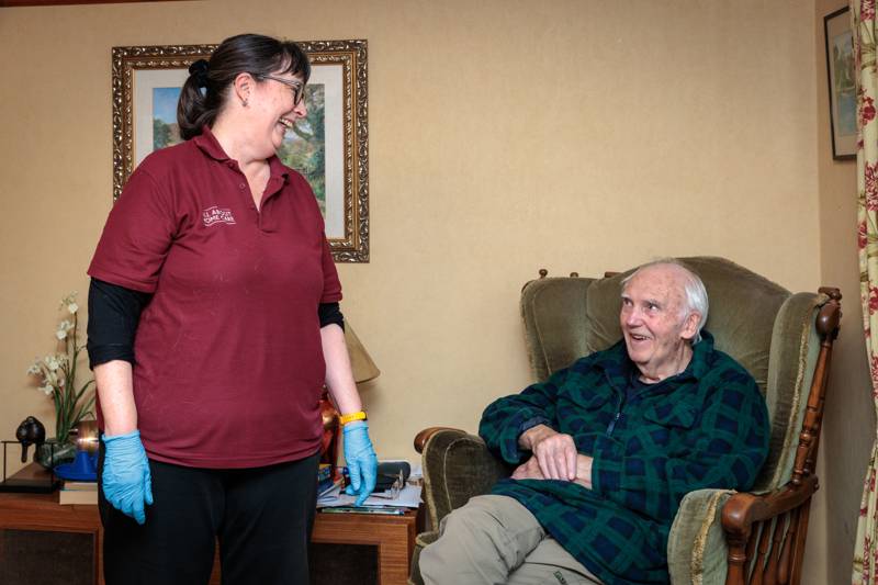 A carer chatting with a client at home