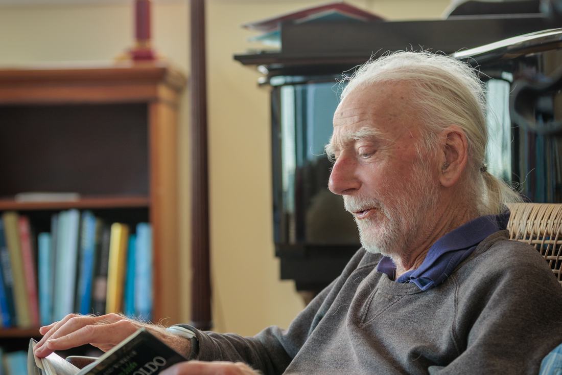 A client sitting quietly in his armchair with a book
