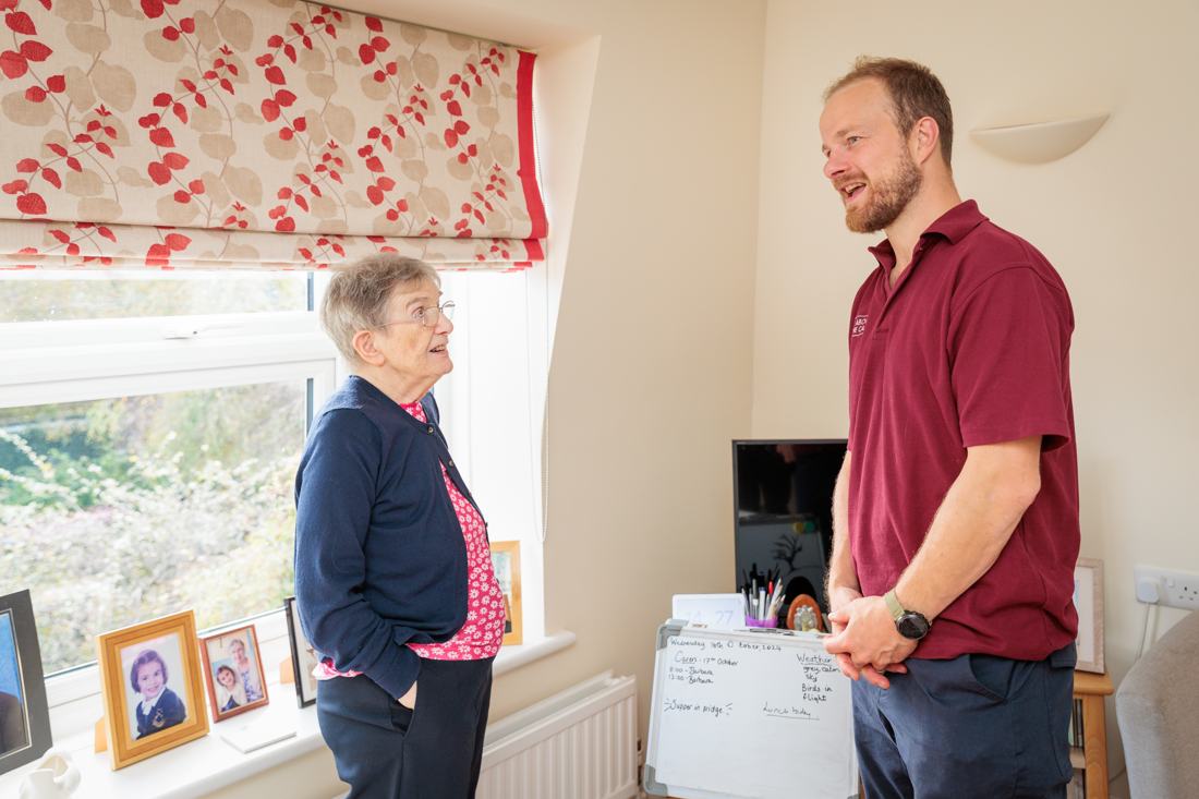 A member of our team chatting with a client at home