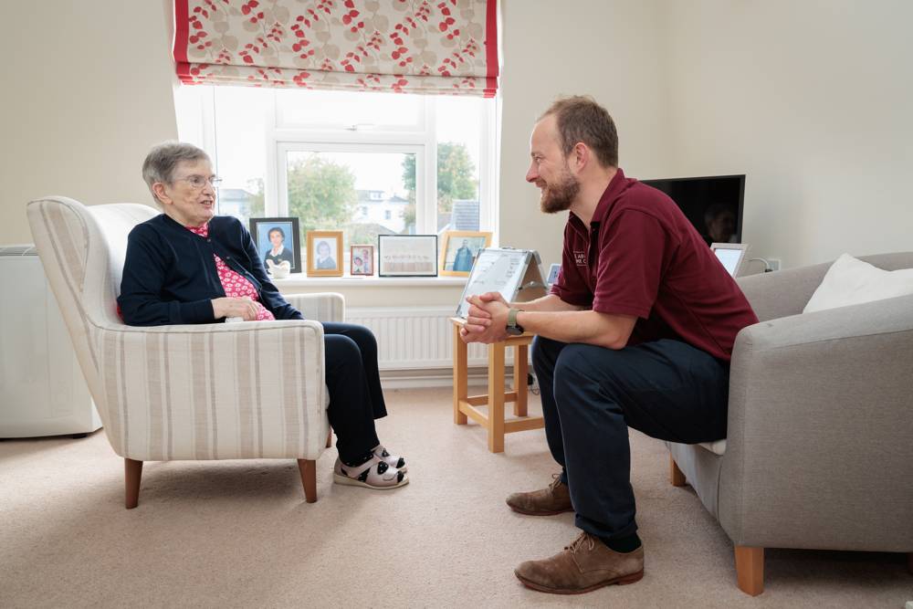 A member of our team talking with a client at home
